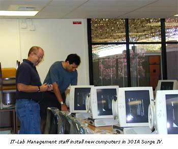 Lab Management staff install new computers in 301A Surge IV