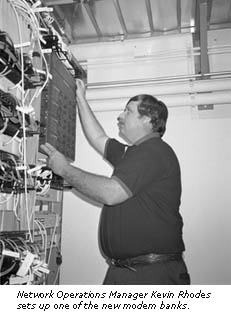 photo of Kevin Rhodes of Communications Resources setting up a new modem bank